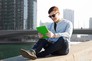 Image showing happy young man with tablet pc over city bridge
