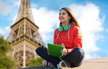 Image showing happy young woman with tablet pc and headphones