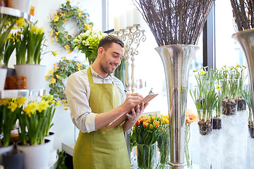 Image showing florist man with clipboard at flower shop