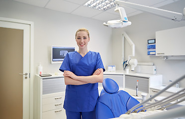 Image showing happy young female dentist at dental clinic office