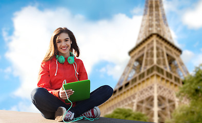 Image showing happy young woman with tablet pc and headphones