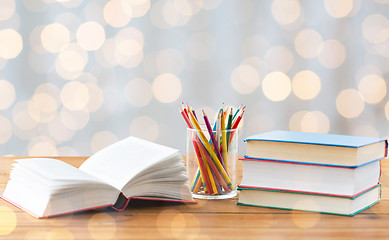 Image showing close up of crayons or color pencils and books