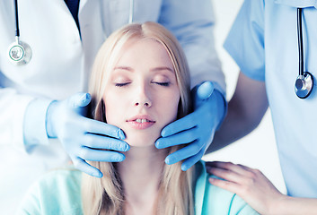 Image showing plastic surgeon or doctor with patient