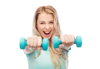 Image showing smiling beautiful young sporty woman with dumbbell