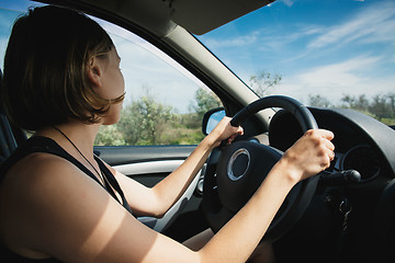 Image showing the girl goes behind the wheel of a car