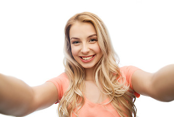 Image showing happy smiling young woman taking selfie