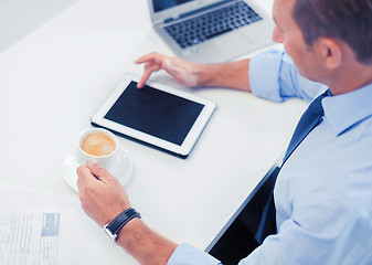 Image showing businessman with tablet pc and coffee in office