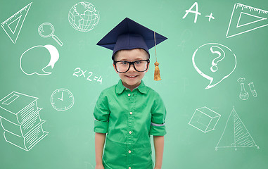 Image showing boy in bachelor hat and eyeglasses over blackboard