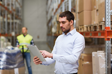 Image showing businessman with tablet pc at warehouse