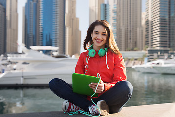 Image showing happy young woman with tablet pc and headphones