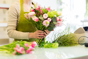 Image showing close up of woman making bunch at flower shop