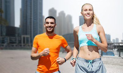 Image showing couple running over dubai city street background