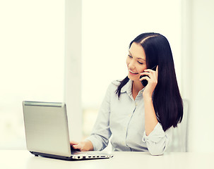 Image showing businesswoman with laptop and cell phone