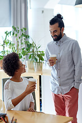 Image showing happy man and woman drinking coffee in office