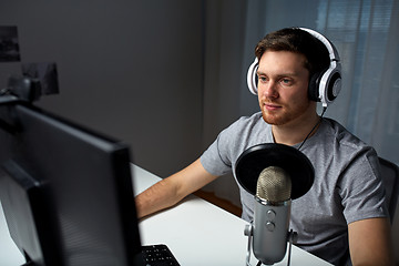 Image showing man in headset playing computer video game at home