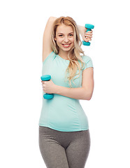 Image showing happy beautiful young sporty woman with dumbbells