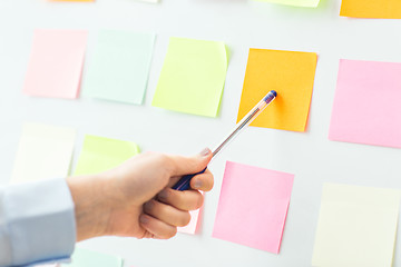 Image showing close up of hand pointing to sticker on flip chart