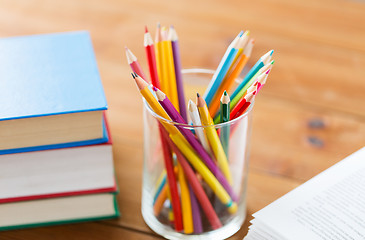 Image showing close up of crayons or color pencils and books