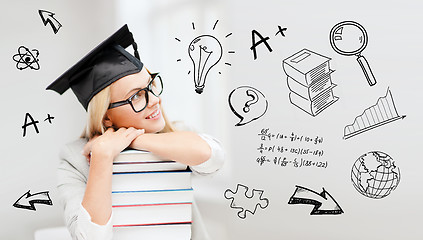 Image showing happy student woman in mortarboard with books