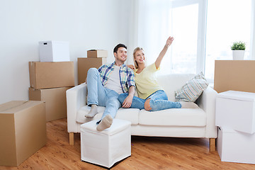 Image showing couple with boxes moving to new home and dreaming