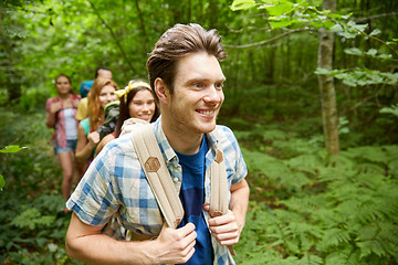 Image showing group of smiling friends with backpacks hiking