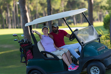 Image showing couple in buggy on golf course