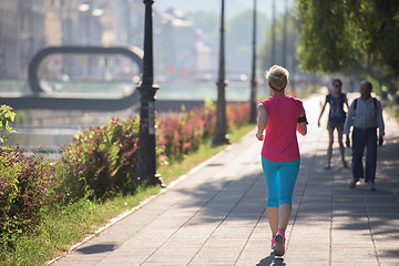 Image showing sporty woman running  on sidewalk