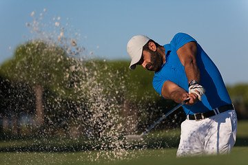 Image showing pro golfer hitting a sand bunker shot