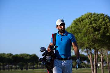 Image showing golfer  walking and carrying bag