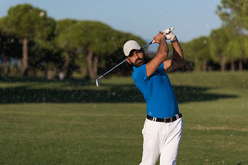 Image showing pro golfer hitting a sand bunker shot