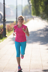 Image showing sporty woman running  on sidewalk