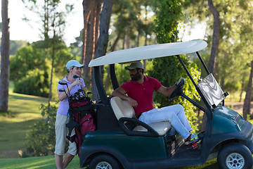 Image showing couple in buggy on golf course