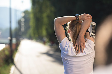 Image showing blonde woman  stretching before morning jogging