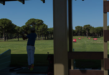 Image showing golf player practicing shot on training
