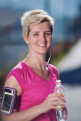 Image showing woman drinking  water after  jogging