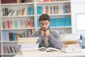 Image showing portrait of student while reading book  in school library