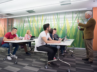 Image showing teacher with a group of students in classroom