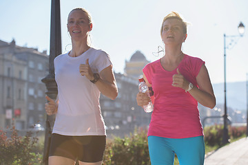 Image showing female friends jogging