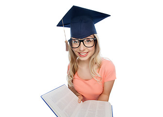 Image showing student woman in mortarboard with encyclopedia