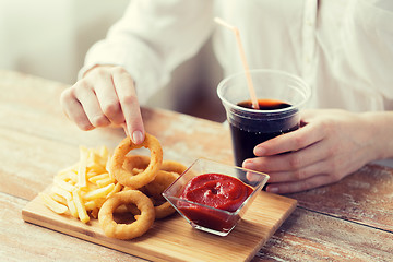 Image showing close up of woman with snacks and cola