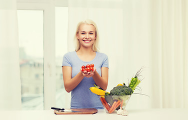 Image showing smiling young woman cooking vegetables at home