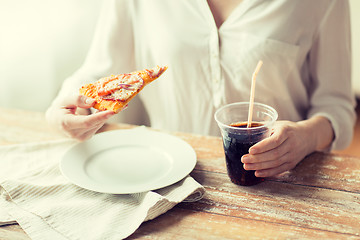 Image showing close up of woman with pizza and cola drink