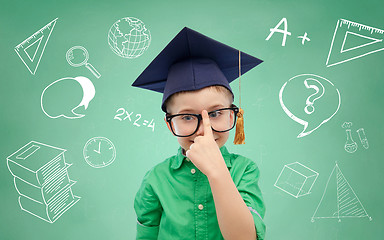 Image showing boy in bachelor hat and eyeglasses over blackboard