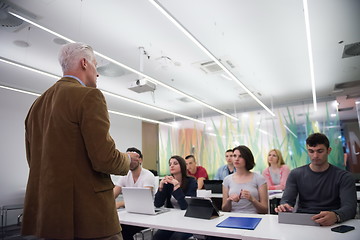 Image showing teacher with a group of students in classroom