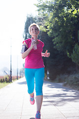 Image showing sporty woman running  on sidewalk