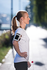 Image showing woman drinking  water after  jogging