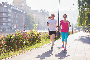 Image showing female friends jogging