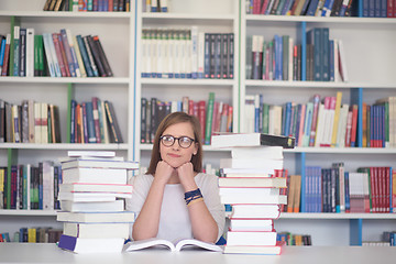 Image showing female student study in library, using tablet and searching for 