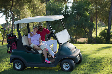 Image showing couple in buggy on golf course