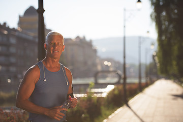 Image showing portrait of handsome senior jogging man